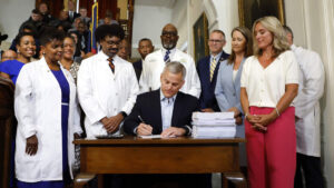 NC budget with year-delayed raises is now law. Gov. Stein signs spending plan